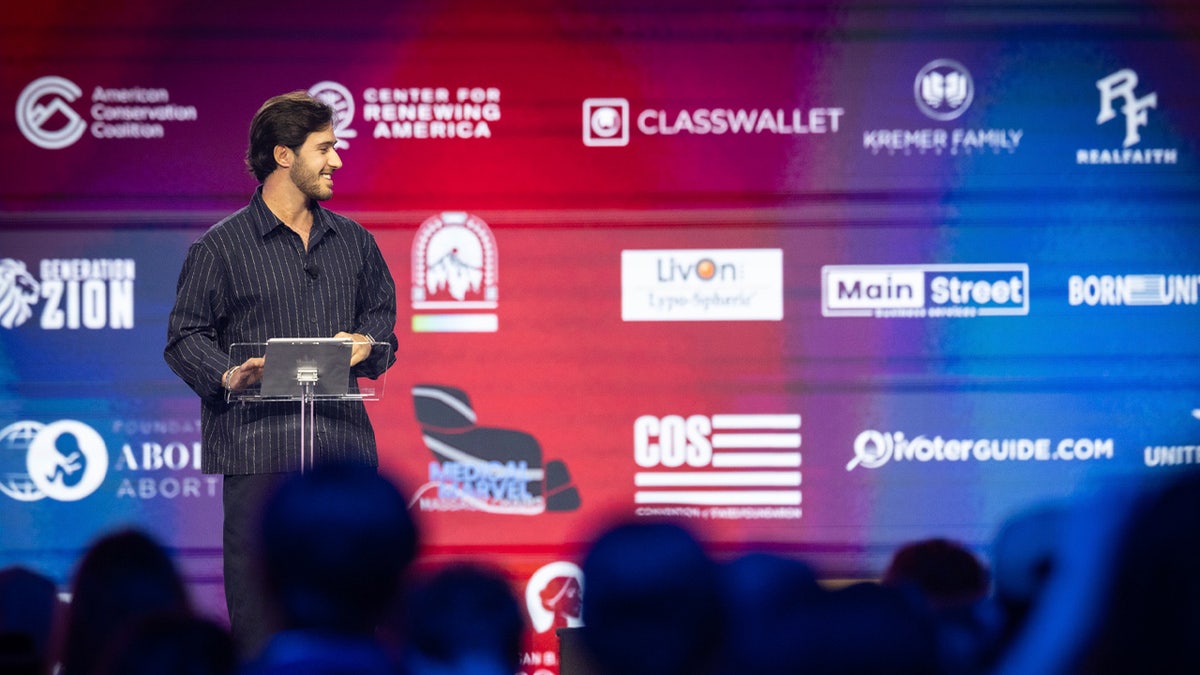 Omer Shem Tov speaking on TPUSA stage