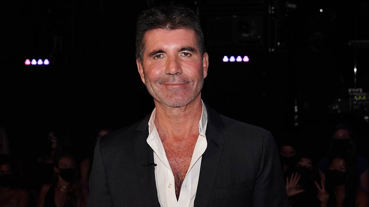 Simon Cowell smiling during a taping
