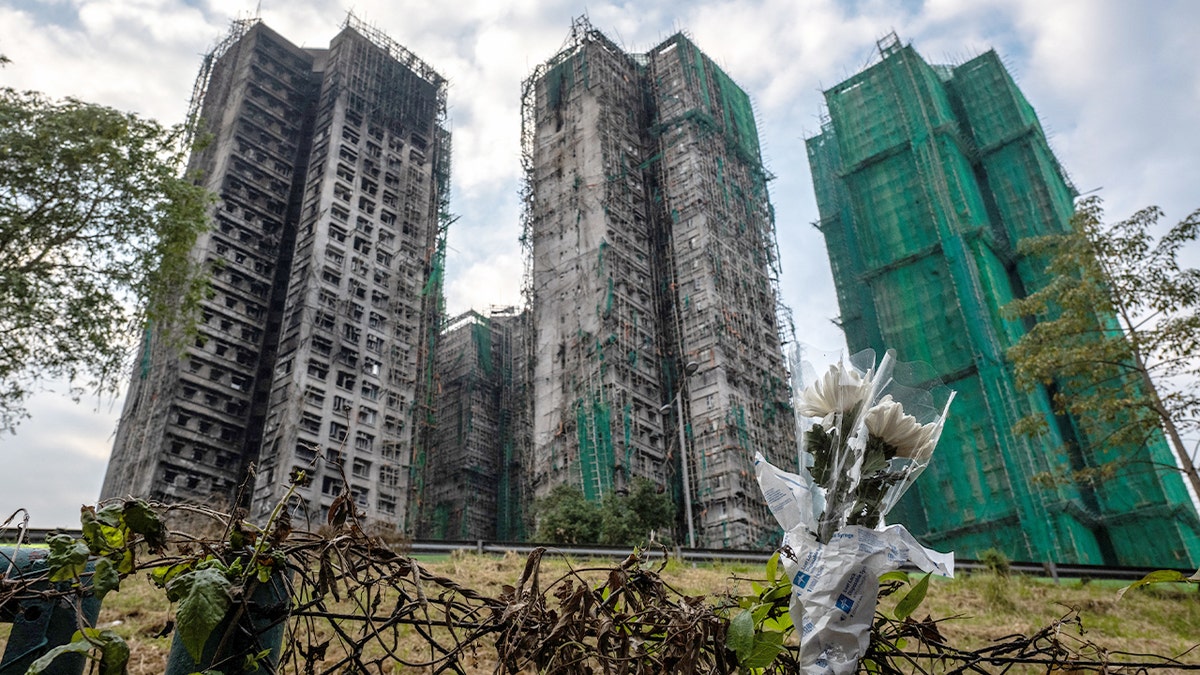 Bouquets are placed outside a Hong Kong apartment complex following a fatal residential fire.