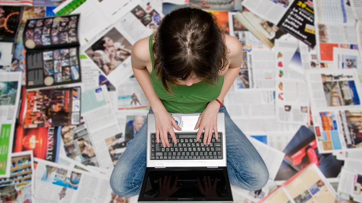 A teen looks at her laptop