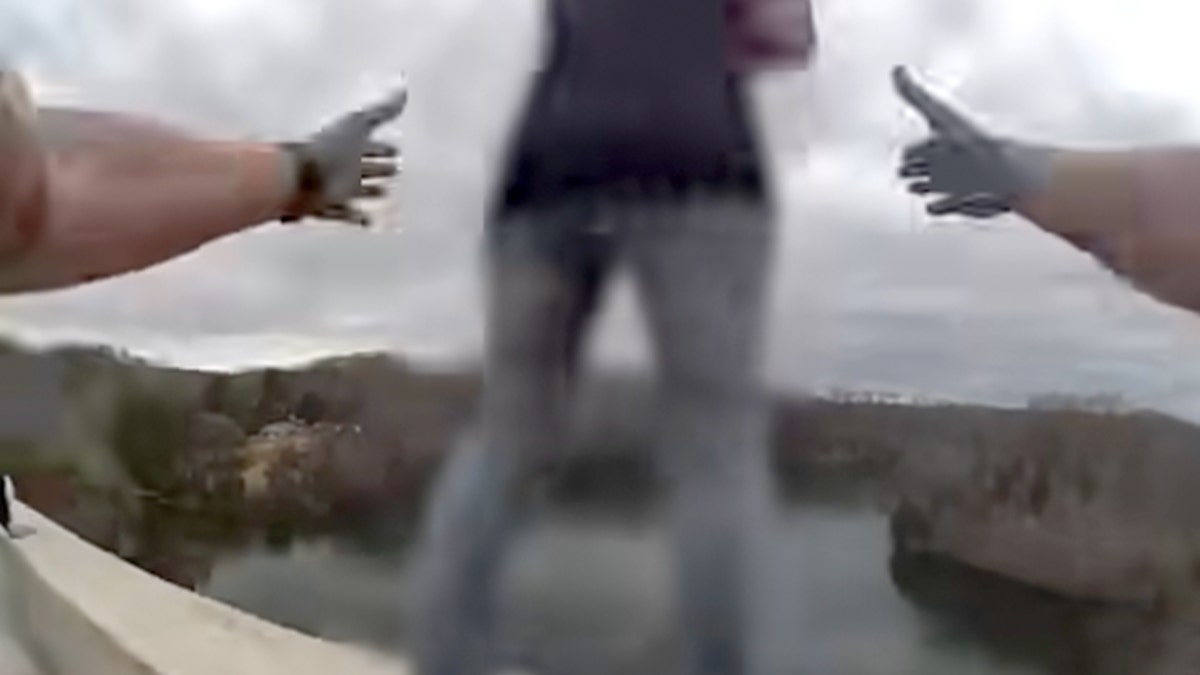 Video footage of a woman on a bridge in Tennessee.