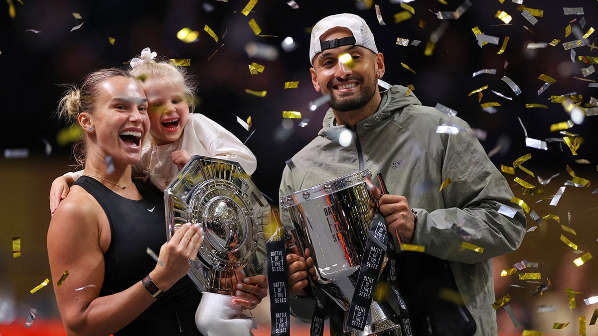 Aryna Sabalenka and Nick Kyrgios hold trophies