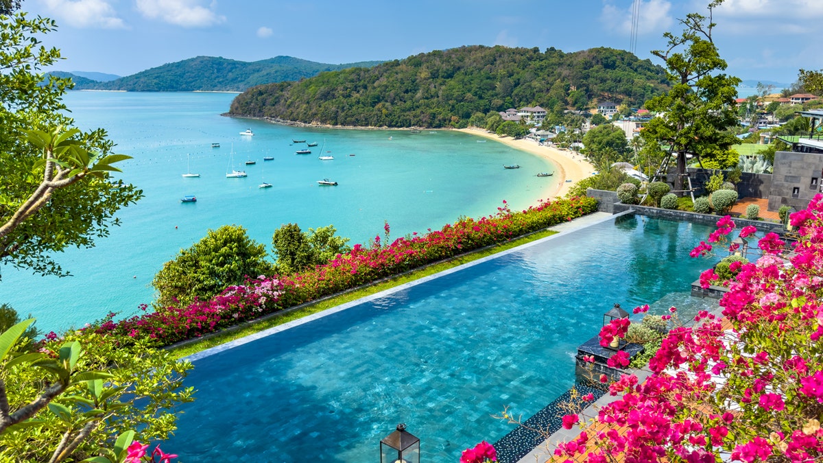 aerial view of thailand beach with infinity pool and flowers