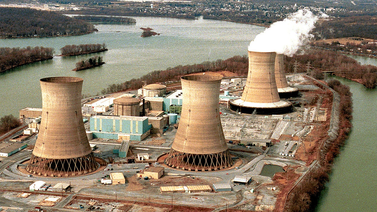 A wide view shows the Three Mile Island nuclear facility with the damaged reactor number two in the foreground.