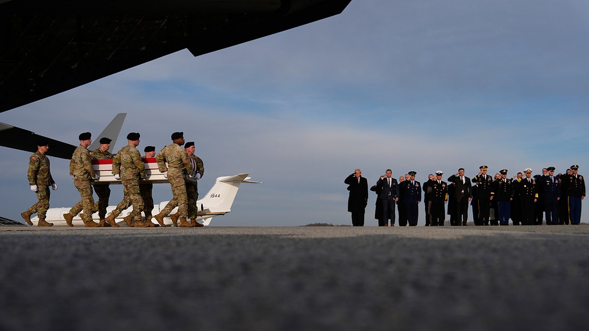 President Donald Trump and Defense Secretary Pete Hegseth watching transfer case at Dover Air Force Base