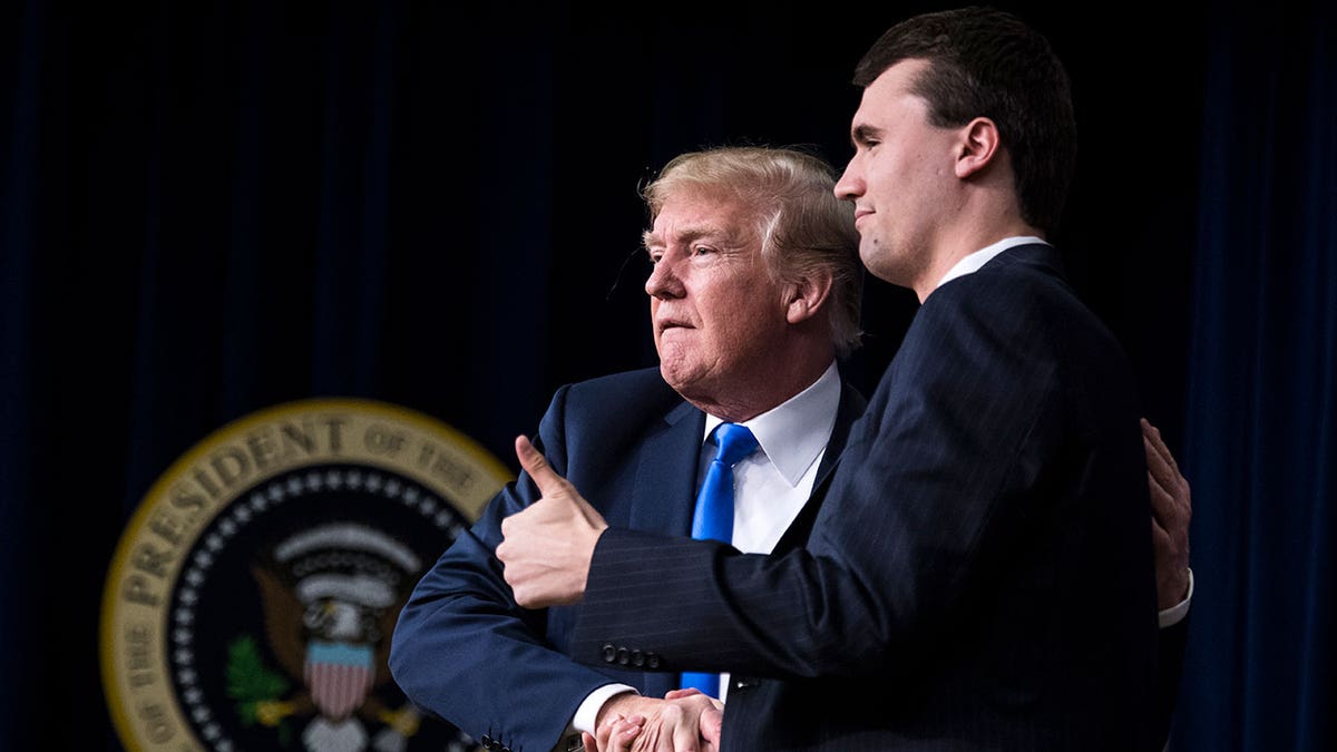 President Donald Trump shakes hands with Charlie Kirk in March 22, 2018.