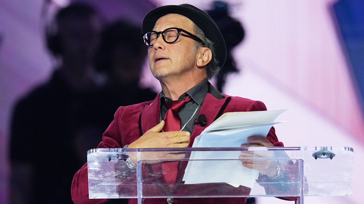 Rob Schneider speaking at Turning Point USA's AmericaFest 2025 in Phoenix