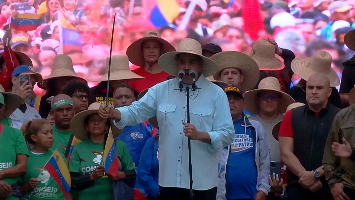 Maduro issues warning while holding a sword