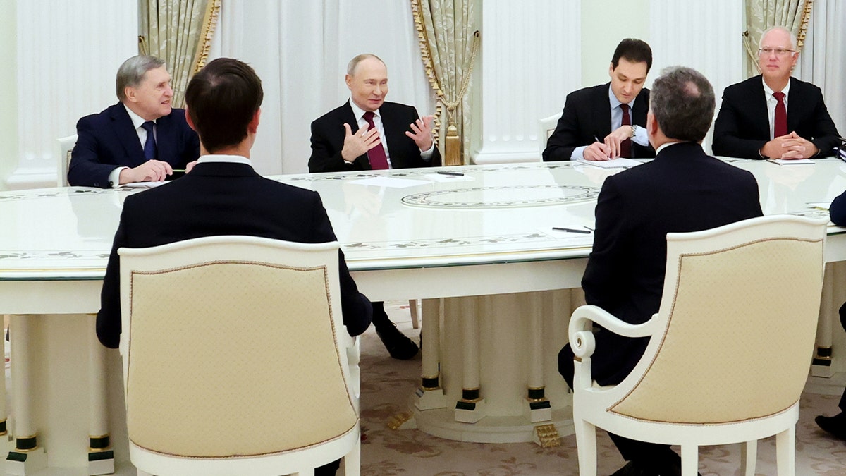 Delegates from the U.S. and Russia walk together inside the Kremlin ahead of a high-level meeting.