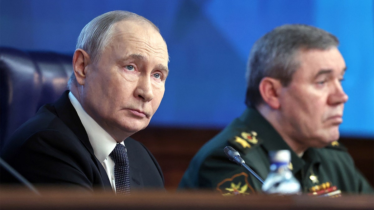 Two senior Russian officials listen during a high-level military meeting.