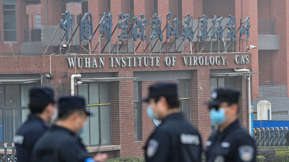 Officers outside the Wuhan Institute of Virology in China