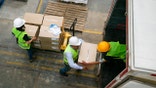 Men load packages onto a cargo truck