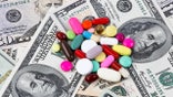 An image of a pile of pills on top of a stack of money