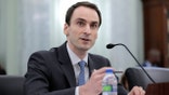 A U.S. official speaks to senators during a hearing on national artificial intelligence strategy.