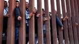 Migrants try to enter United States but stopped by border wall