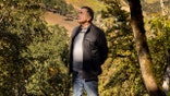 Moe Momtazi looks up while standing in his vineyard.