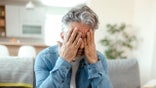 Older man rubbing his eyes very tired