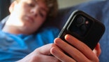 Teenager using a cellphone
