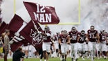 Texas A&M Aggies runs from the tunnel