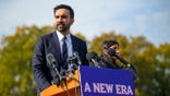 Zohran Mamdani speaking at podium