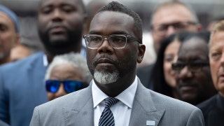 Why would a city mayor defend a dictator while his own streets continue to burn?