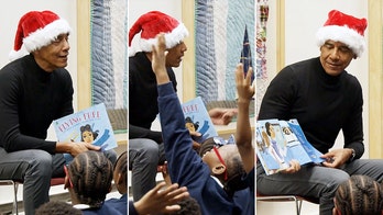 Obama surprises Chicago students in Santa hat for holiday library storytime reading session