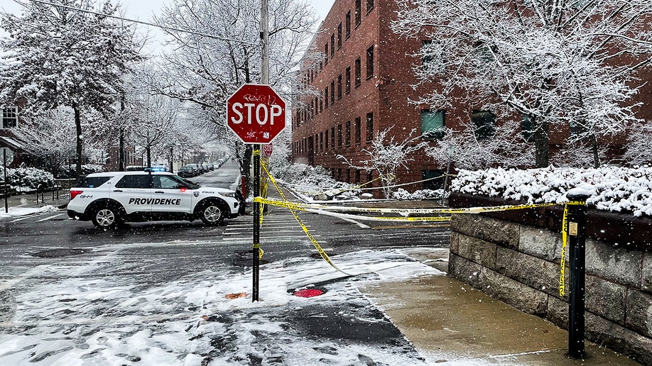 police vehicle and police tape on campus
