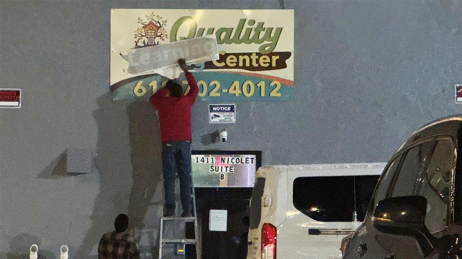 Quality Learning Center sign being corrected