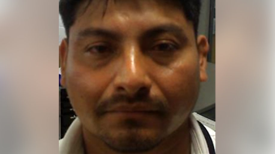 Man looks into the camera in a close-up indoor photo.