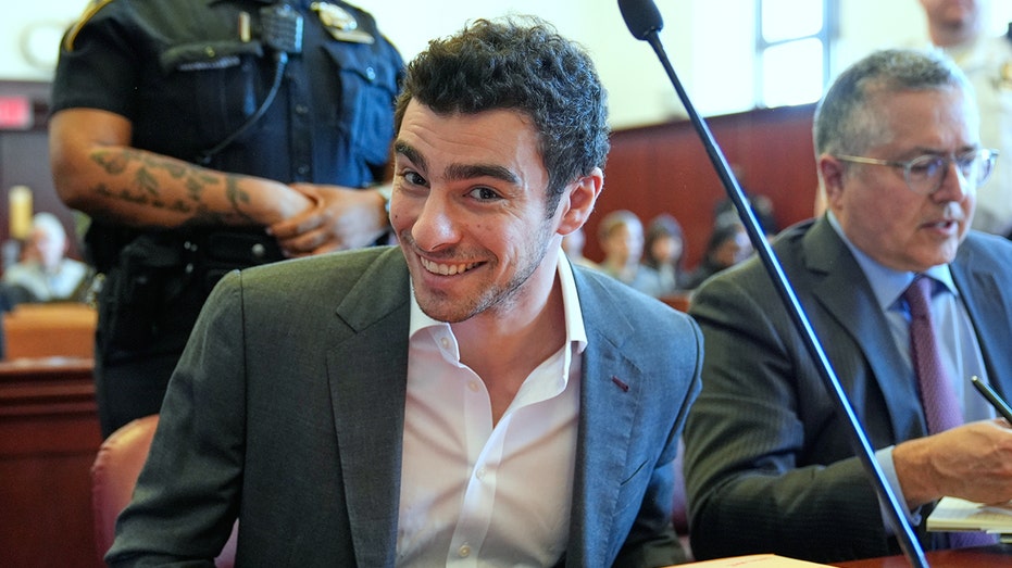 Luigi Mangione smiles for cameras in court as defense claims police violated his rights