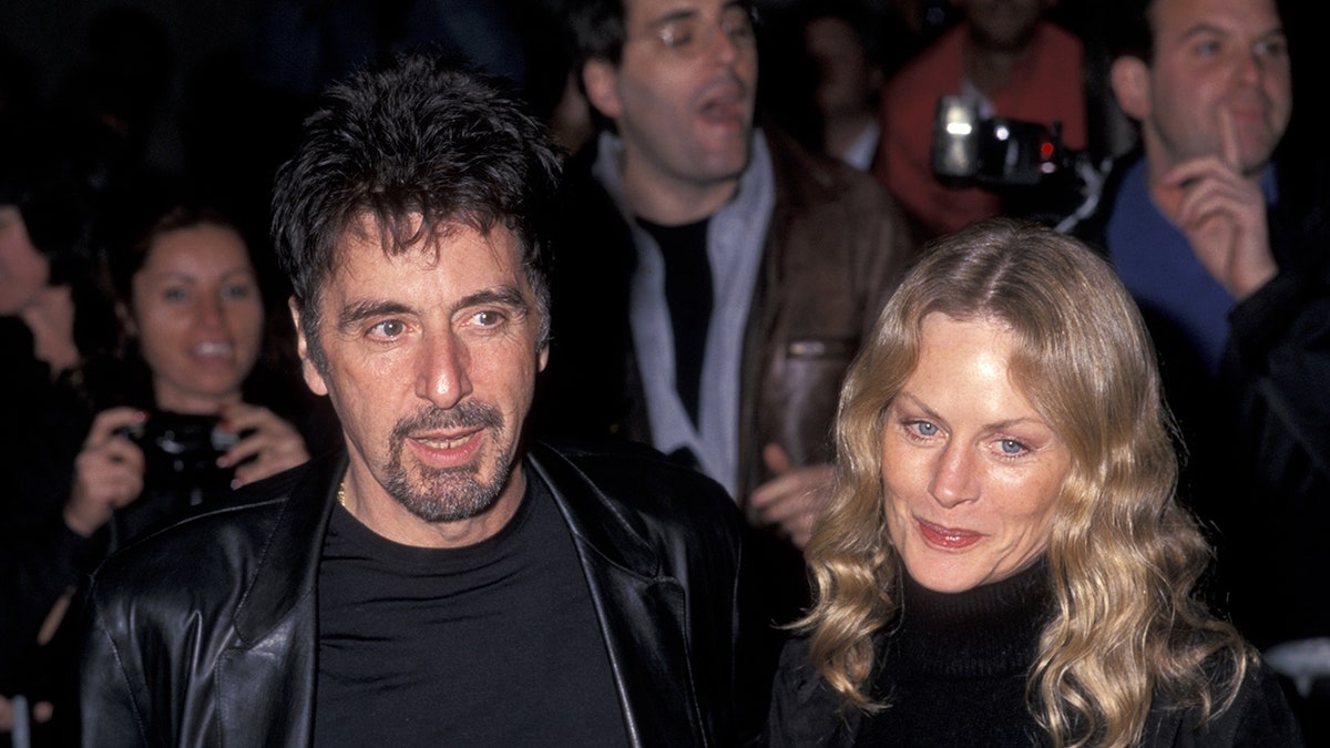 Beverly D'Angelo and Al Pacino walking together in matching black attire.