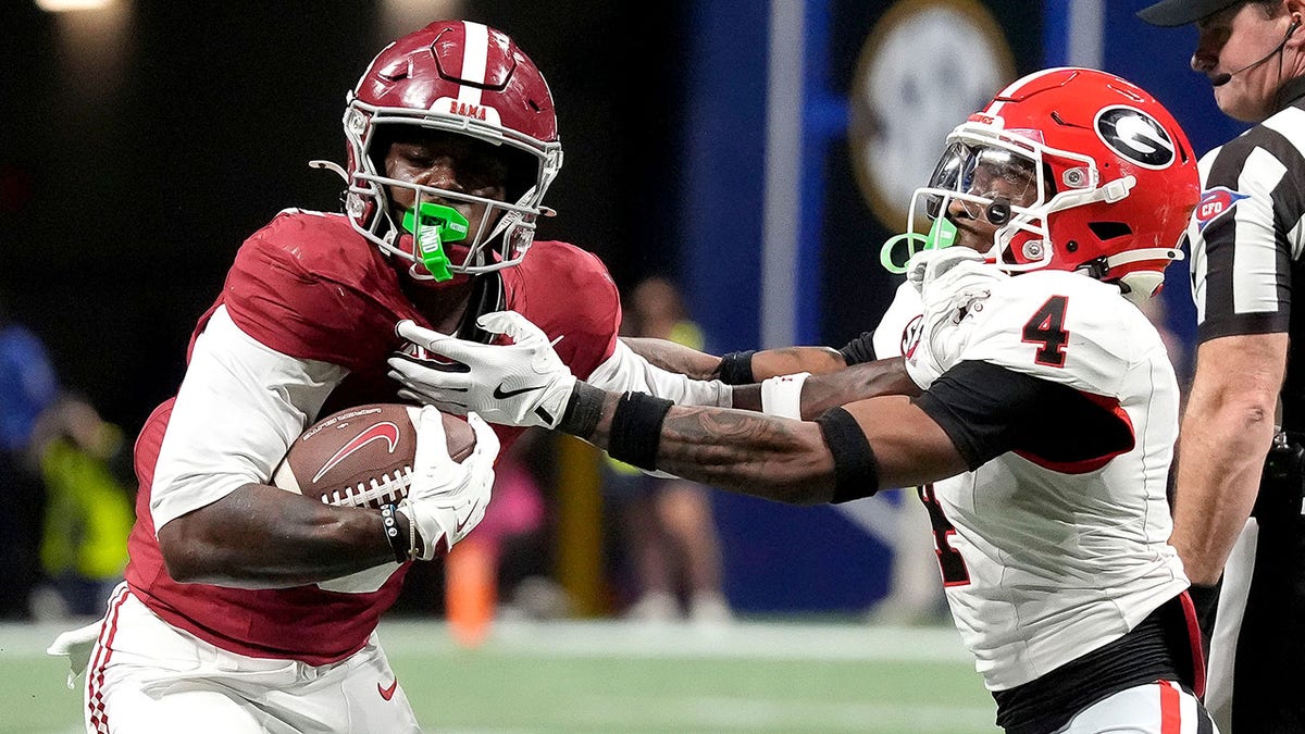 Germie Bernard uses a stiff arm