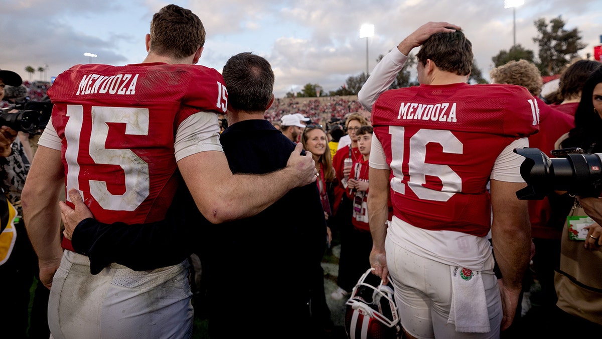 Alberto and Fernando Mendoza are embraced by Indiana players and fans after the Rose Bowl.