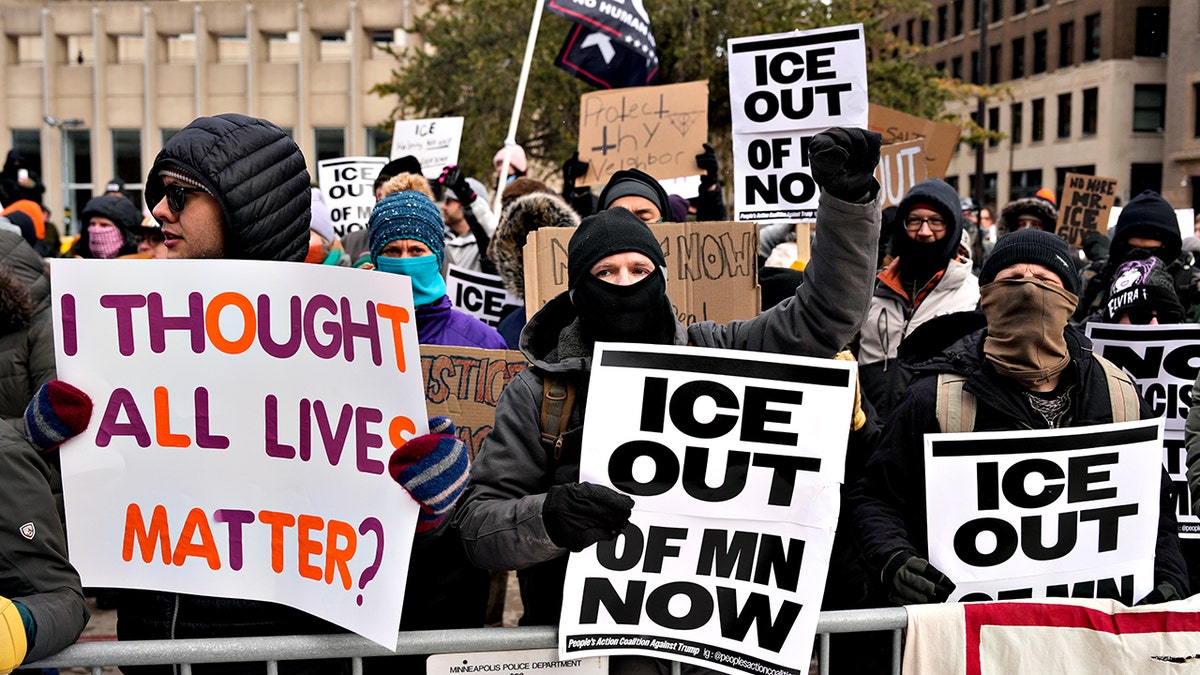 Anti-ICE protesters holding signs