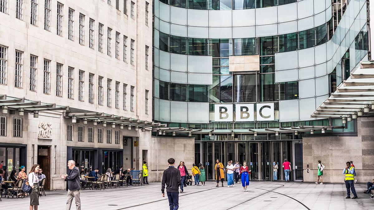 People outside the main entrance to the BBC's headquarters, Broadcasting House in central London