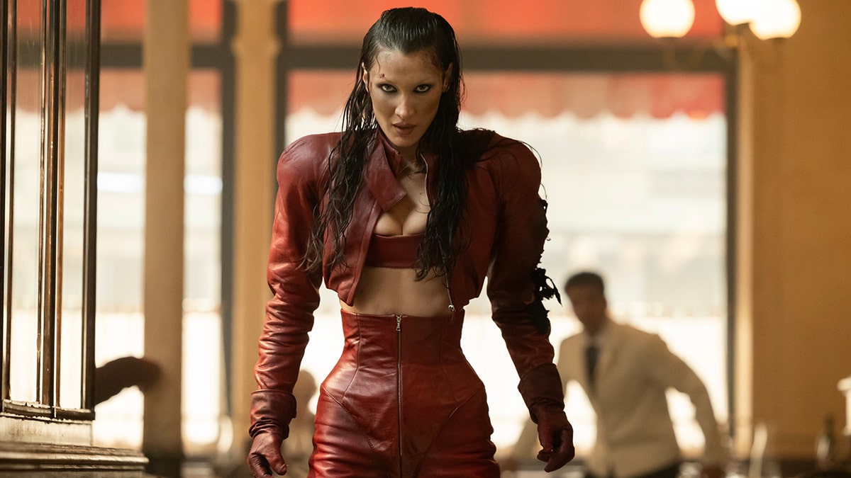Bella Hadid in a cropped red leather jacket and matching high-waisted pants for FX's "The Beauty."