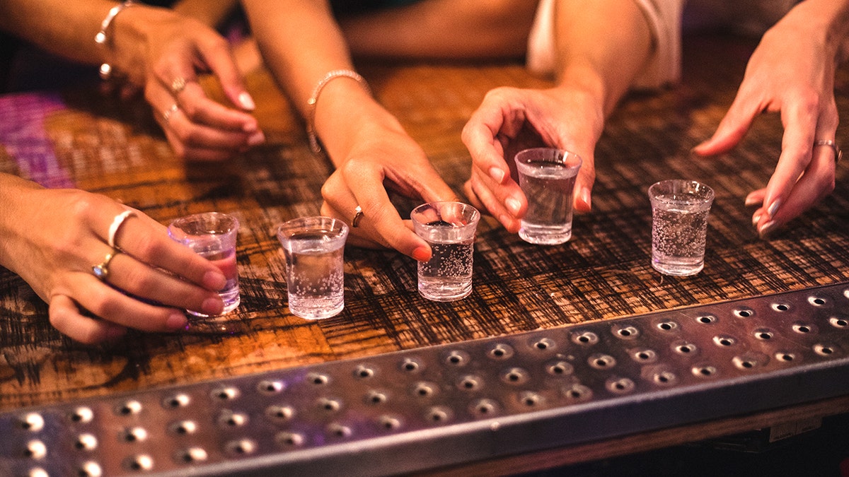 Group ordering clear shots at bar
