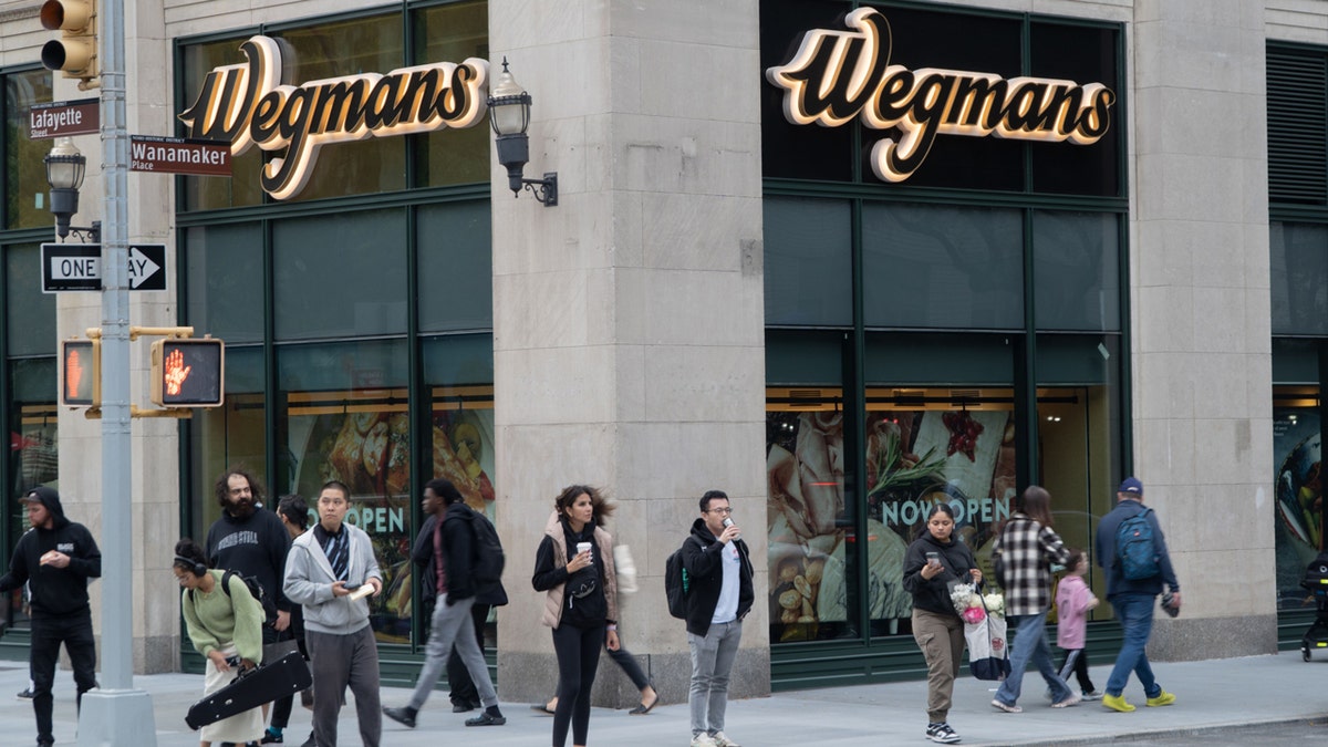 outside wegmans store with shoppers