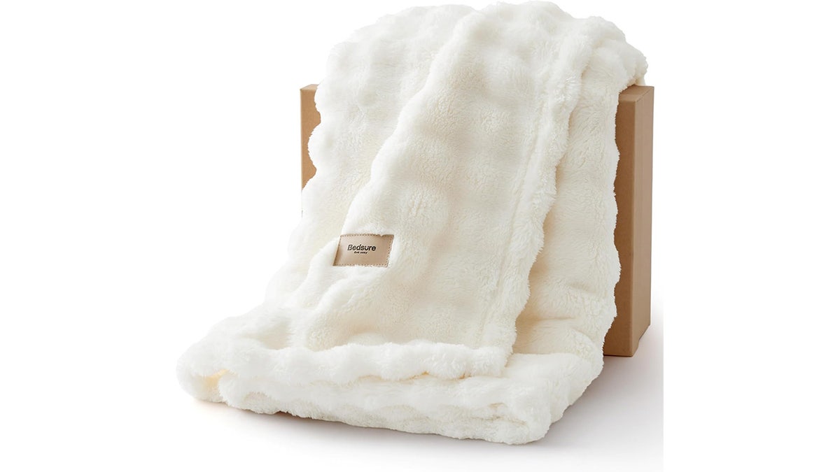 No need to buy a new sofa, just get a throw in a trendy shade.