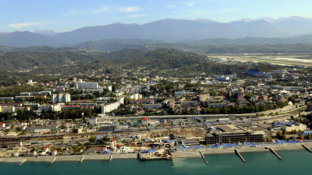 aerial view of port city with docks, buildings, roads