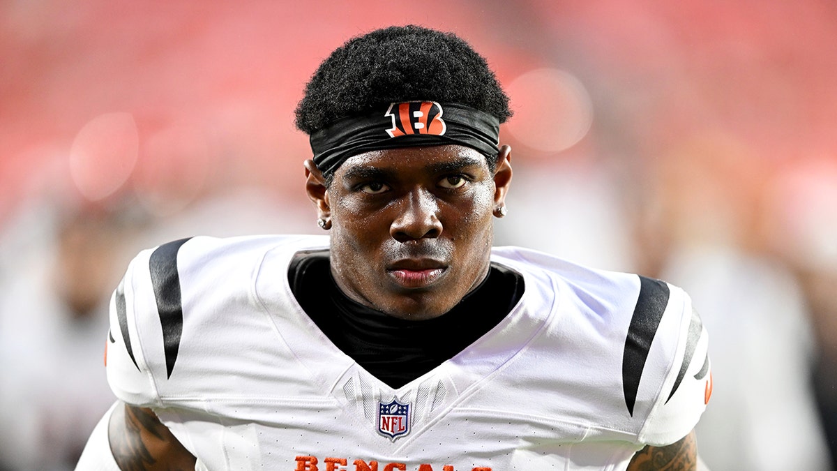 Cam Taylor-Britt looks on field