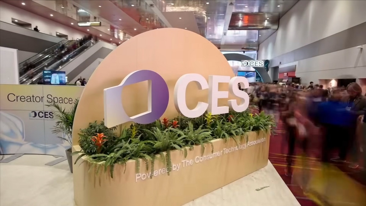 CES sign with people passing by.
