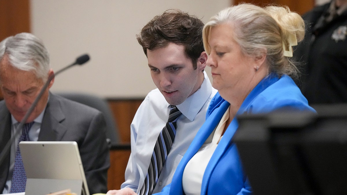 Tyler Robinson sitting beside defense attorney Kathryn Nester in court
