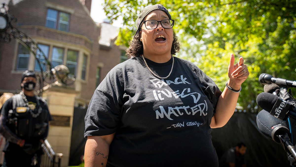 BLM leader in black shirt at outside rally