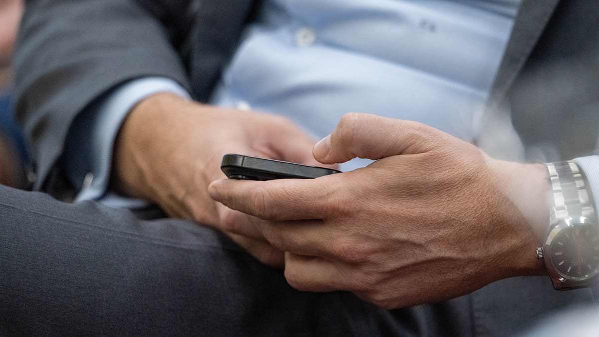 Homem verificando seu telefone.