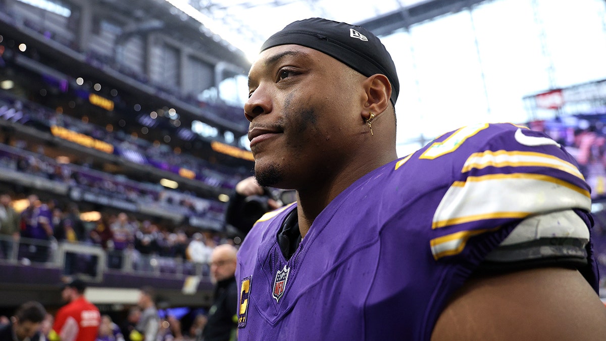 C.J. Ham looks on field