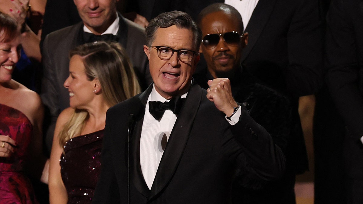 Stephen Colbert accepting an award on stage at the Peacock Theatre in Los Angeles