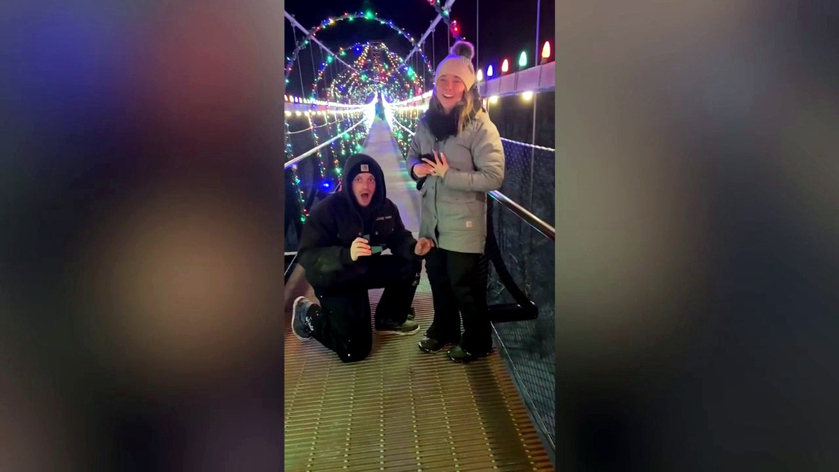 Trevor Van Camp and Danielle Jenkins look shocked as they stand on the SkyBridge