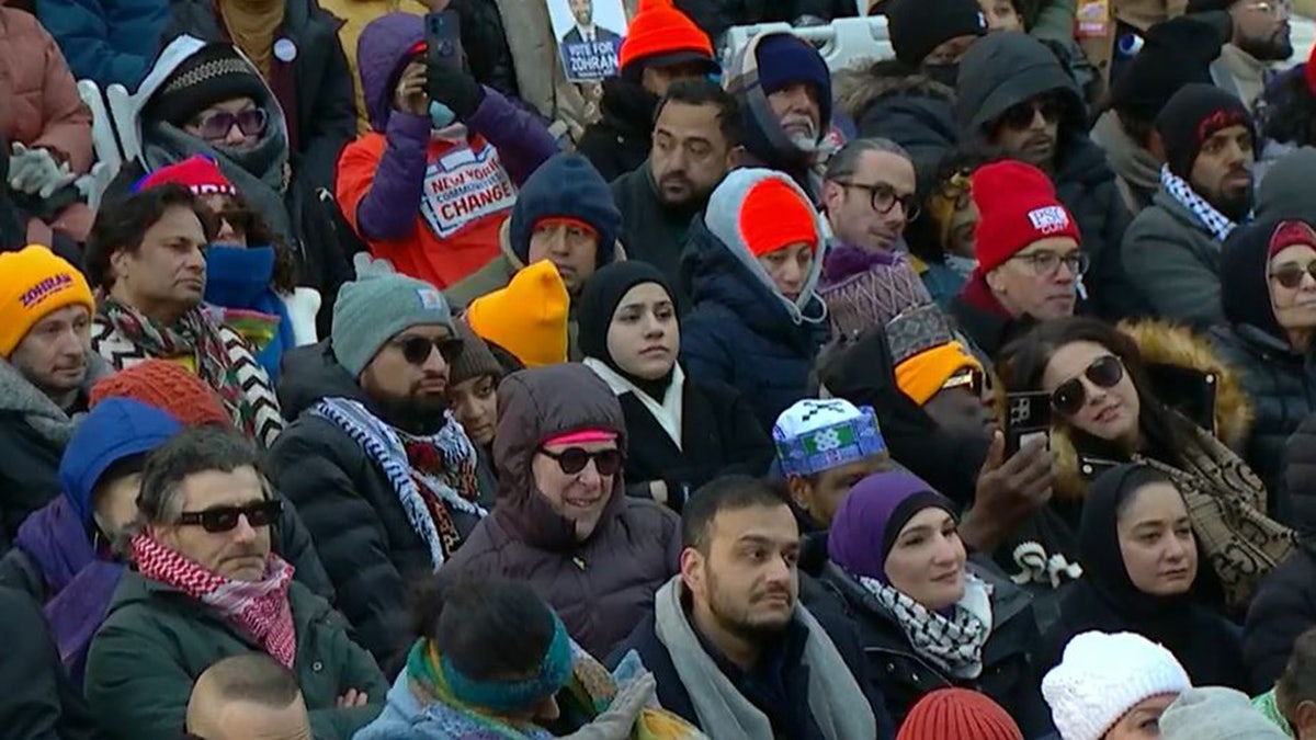 People watch as New York City Mayor Zohran Mamdani is inaugurated, Thursday, Jan. 1, 2026, outside City Hall.