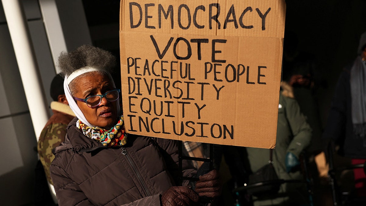 People march outside the office of hedge fund billionaire Bill Ackman in New York City